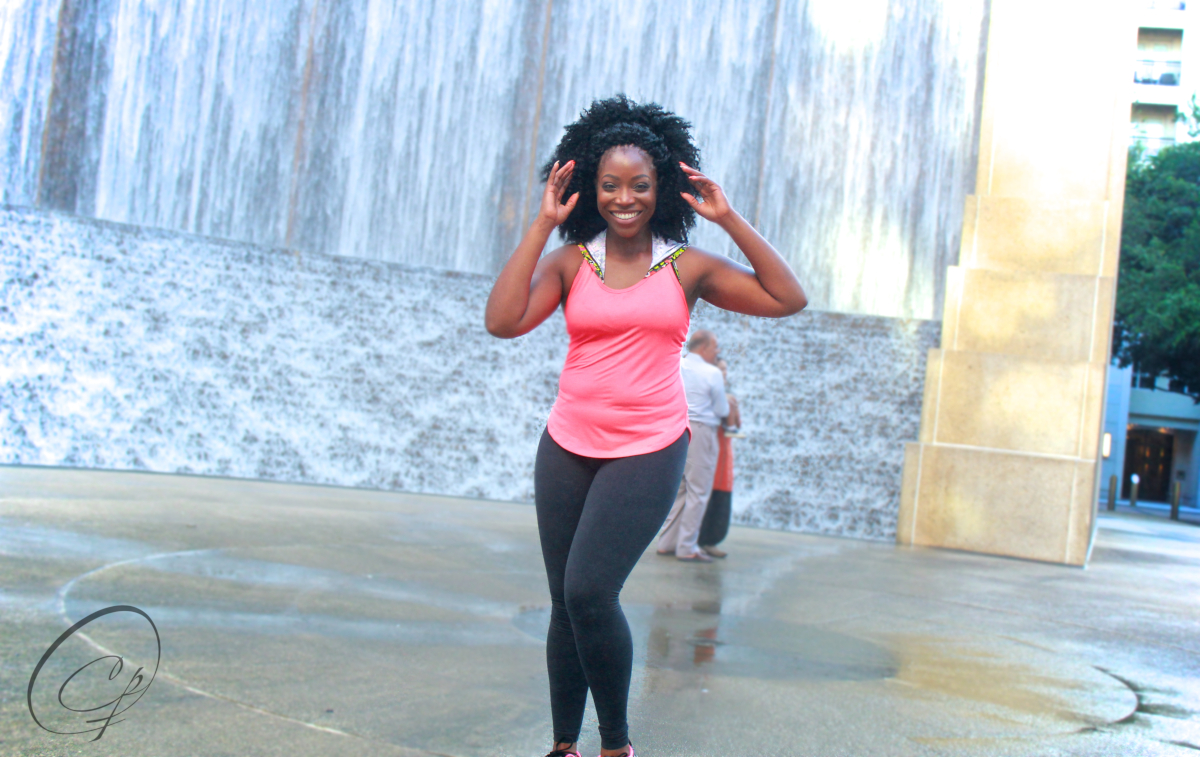 photo of Uchenna Emenaha standing outside in front of a tall gray wall