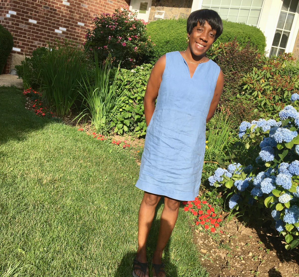 photo of Nedra Stewart standing outside a house
