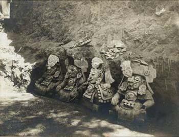 Archival image of four Zapotec urns at excavation site.