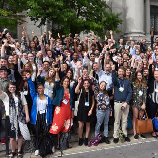 Group photo of over 150 people from the Student Conference on Conservation Science on the steps of the Central Park West Museum entrance.