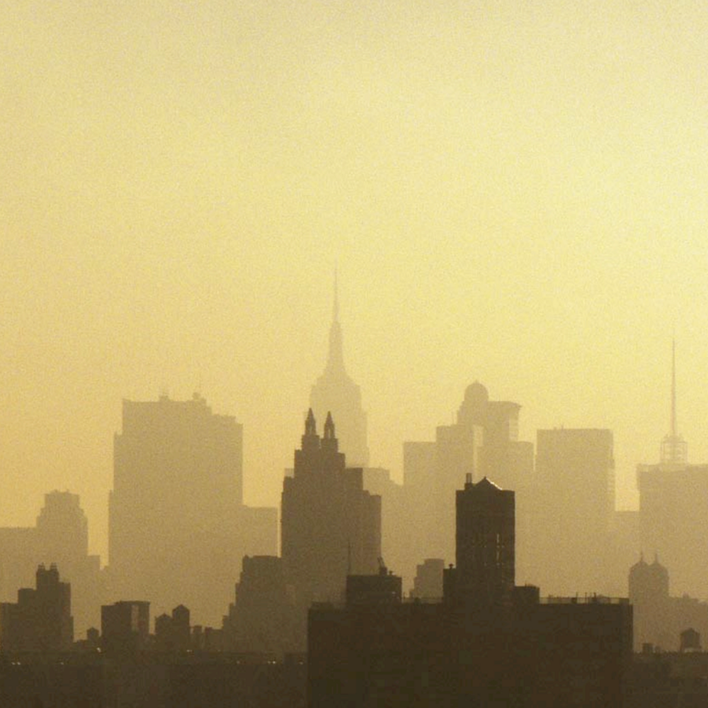 The New York skyline against a hazy sky.