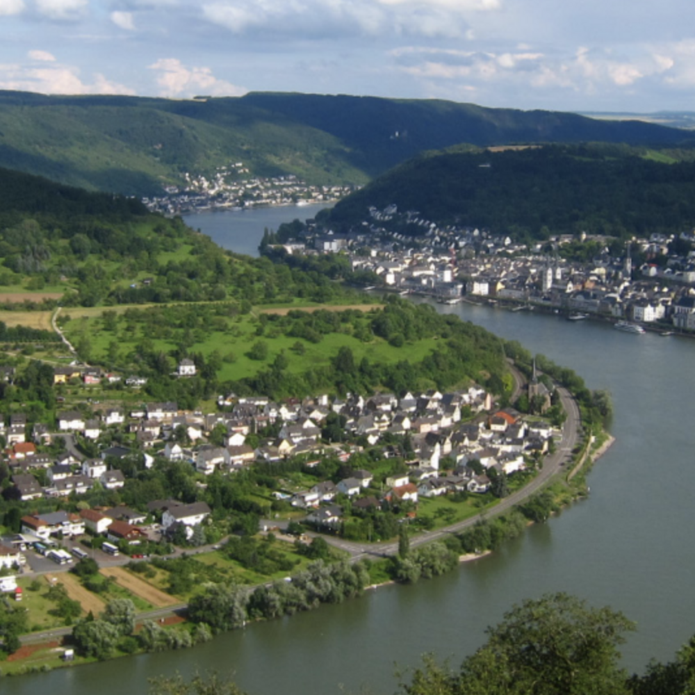 A rive flows with a town on each side.