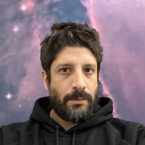 Headshot of Jose Barba-Montoya in front of a background depicting stars and space.