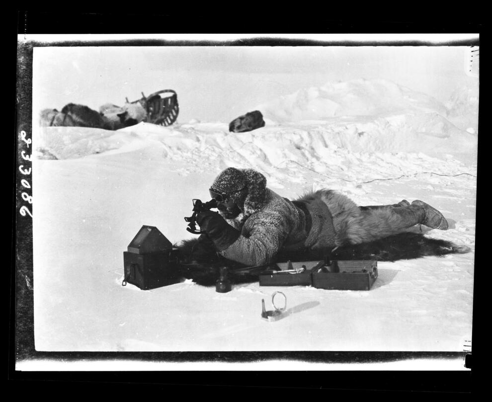 Photograph of Donald Baxter MacMillan taking observations on Polar Sea ice in the Arctic Ocean, April, 1914