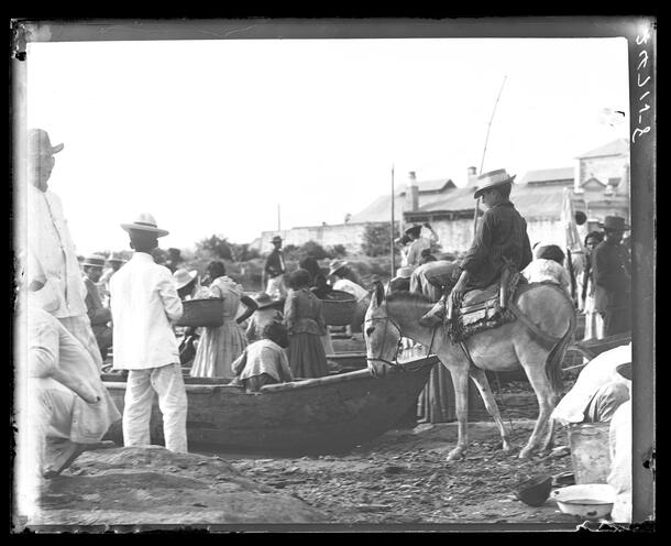 Scene of people and donkey at waterfront market, Barranquilla, Colombia, 1911.