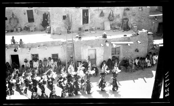 View of people watching a performance of Niman "Home Dance" at Musangnuvi, Second Mesa, featuring Hemiskatsinam ("Jemez katsinas"), Arizona.