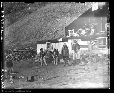 Ow-duk-a-hing-waq, We-we, Edmund Otis Hovey, and Peter Freuchen in front of headquarters house, Etah, Greenland, September 15, 1915. AMNH Research Library, Image no. 234325.