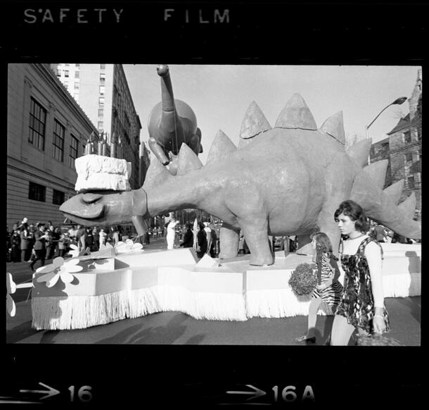 Image of AMNH dinosaur balloon and float, Macy's Thanksgiving Day Parade, American Museum of Natural History, 77th Street, November 1969.