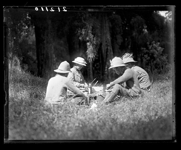 Delia and Carl Akeley eating a picnic lunch with two companions in Elgon Forest, Mount Elgon, Kenya, 1909-1911