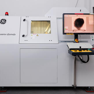 GE CT Scanner with a view on a computer of the object being scanned. 