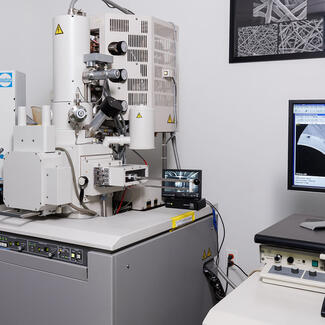 S-4700 scanning electron microscope next to a computer screen that displays the image being scanned.