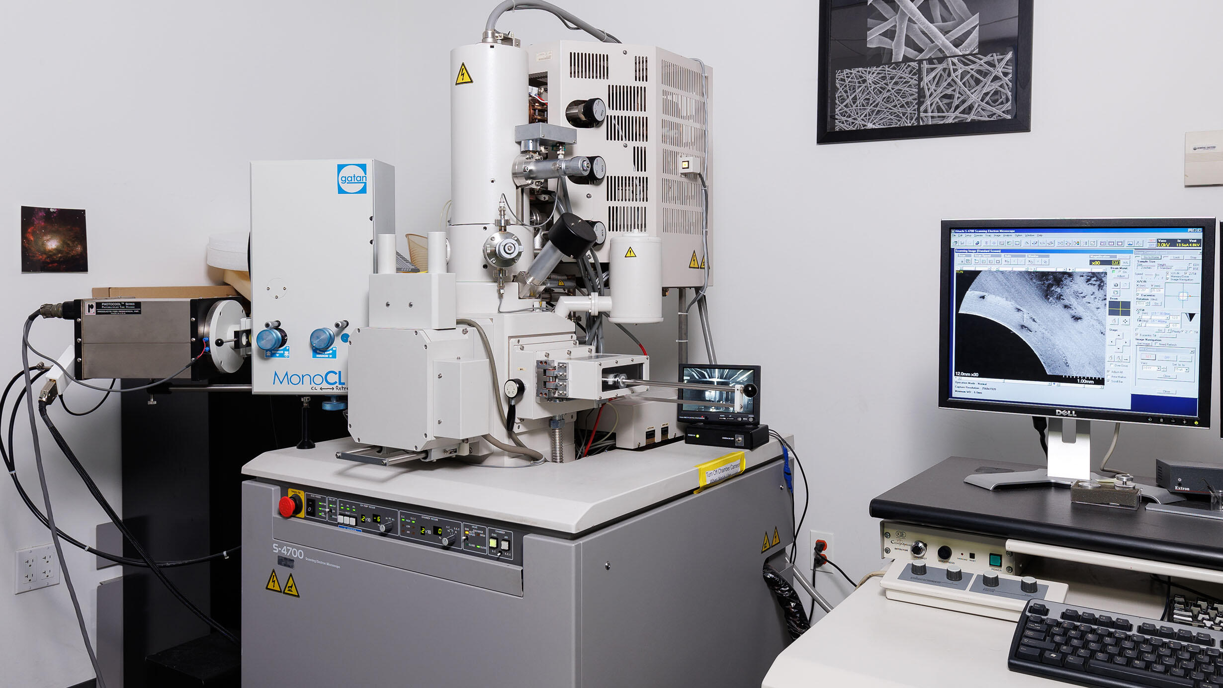 S-4700 scanning electron microscope next to a computer screen that displays the image being scanned.