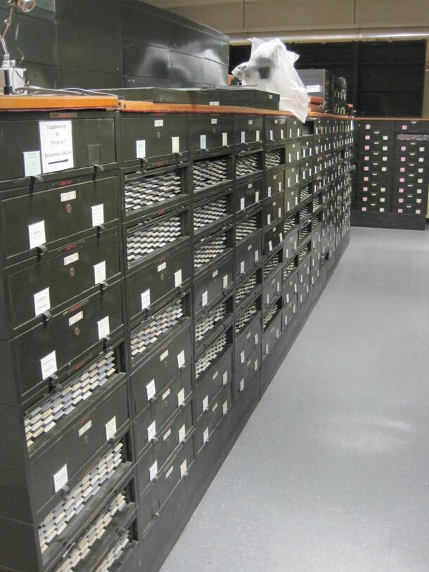 A large room filled with metal slide cabinets.