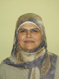 A woman wearing a head scarf and wire-rimmed eyeglasses: Museum staffer Bushra Hussaini.