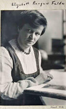 Head and shoulders portrait of artist Elizabeth R. Fulda, holding an open book and looking into the camera.