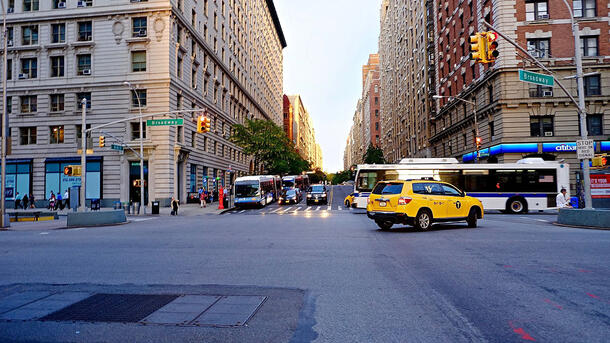 Cab and buses cross the busy intersection at 86th Street and Broadway in Manhattan's Upper West Side.