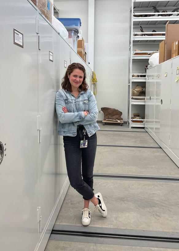 Zoe Kulik leans against a metal filing cabinet inside one of the rooms that houses some of the Musuem's collections.