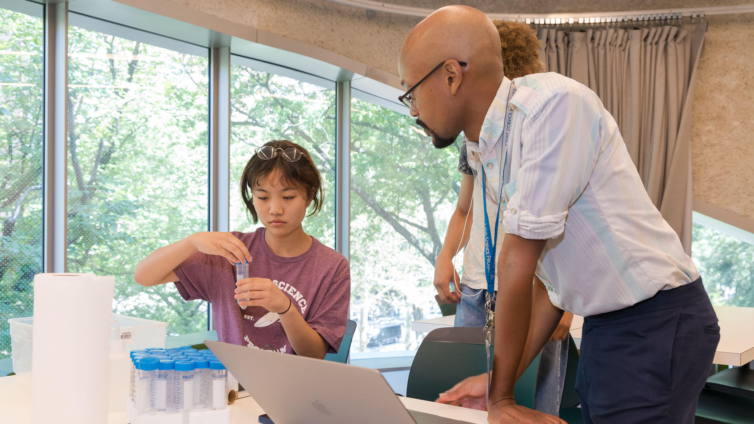 Lang instructor and student who is putting a cap onto a tube.