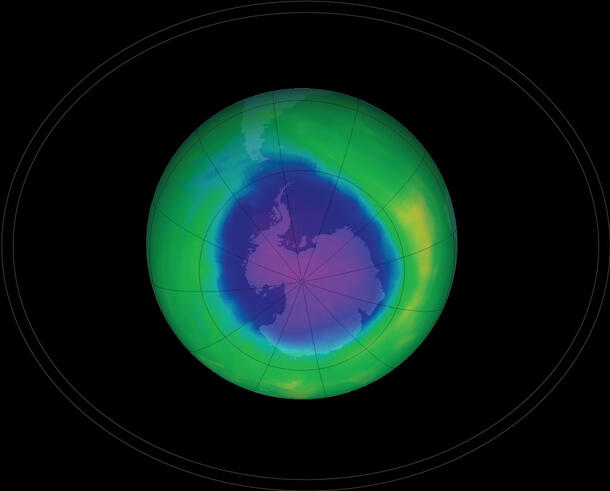 A graphic of planet Earth divided into sections with lines and two bright colors representing the ozone layer and the whole in the ozone.