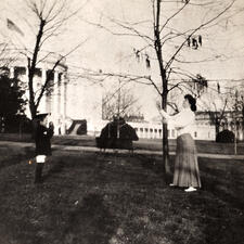Alice Lee Roosevelt throws a ball in the White House garden with a younger child.