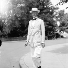 Gifford Pinchot, chief of the Division of Forestry, wearing a hat, light colored suit, and bow tie.