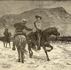 Two cowboys riding horses pass each other by, going in different directions, with another cowboy on horseback and a line of cattle in the background.