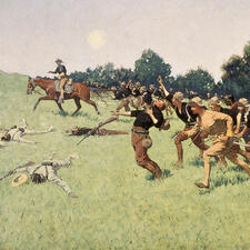 Painting of the battle of San Juan Heights with a line of soldiers behind a person on horseback charging ahead on a grassy hill.