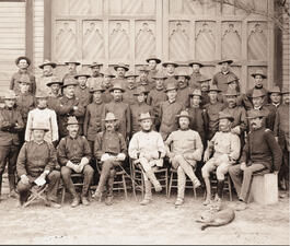 Group photo of about 40 Rough Riders, seated and standing in rows. 