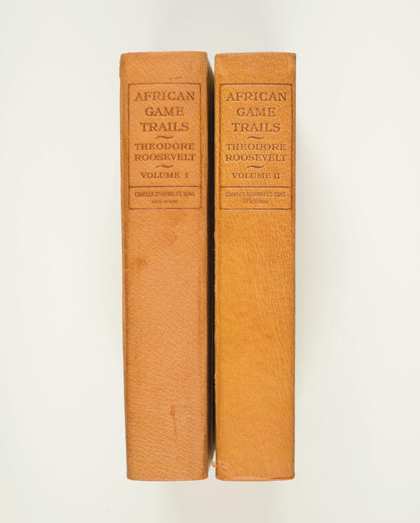 Two books pictured from the spines, which read "African Game Trails" by Theodore Roosevelt Volumes I & II. 