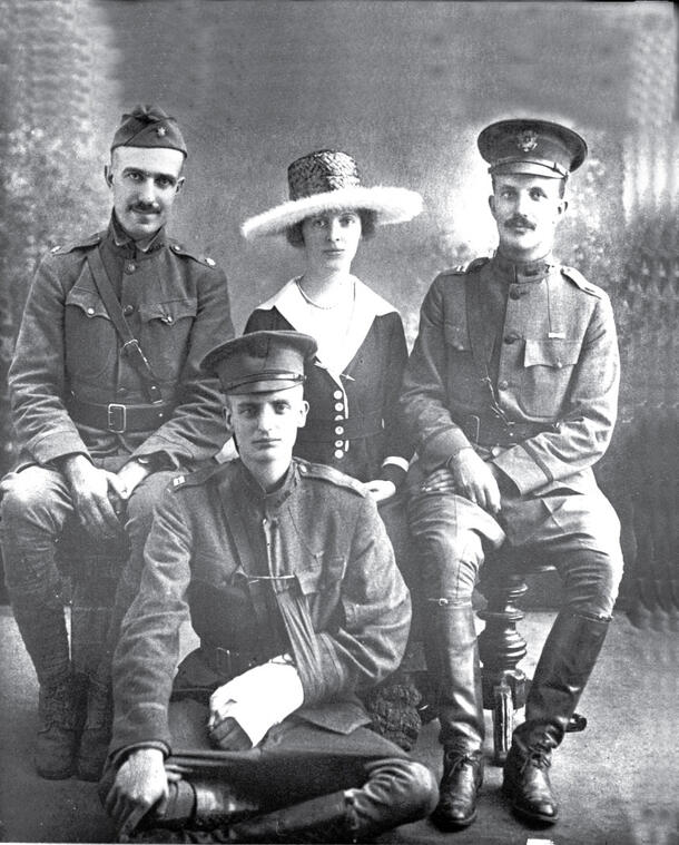 Four people, including Archie Roosevelt seated on the floor, and Kermit Roosevelt seated to the right. 