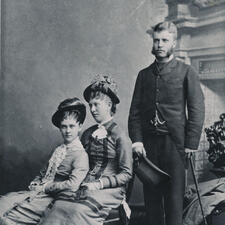 Alice Hathaway Lee (seated, to the left), Theodore Roosevelt (standing on the right) and a third person seated beside Alice.