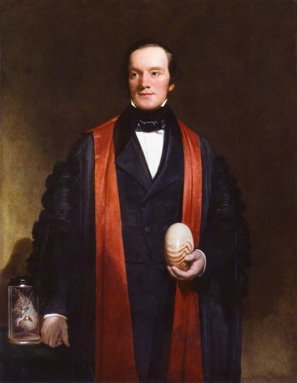A painting of Richard Owen, a British naturalist, posing dressed in academic robes and holding a nautilus in his left hand.
